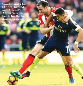  ??  ?? Sunderland’s John O’Shea, behind, and Arsenal’s Alexis Sanchez battle for the ball during yesterday’s match Photo: AP