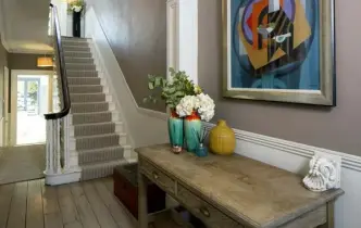  ??  ?? TOP RIGHT:The walls in the hall are painted Charleston Grey. Above the American oak console table is a painting by David Martin