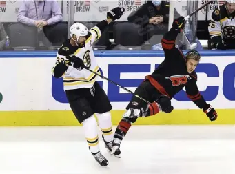  ?? Getty IMages ?? BIG STEP FORWARD: Zdeno Chara delivers a hit on Carolina’s Teuvo Teravainen during Saturday’s Game 3. Chara played 22:02 in the Bruins’ 3-1 win after only playing 15:51 in Game 2.