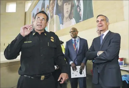  ?? Irfan Khan Los Angeles Times ?? ASSISTANT FIRE CHIEF Ellsworth Fortman, left, with Mayor Eric Garcetti in June 2021, more than a year after the hit-and-run.