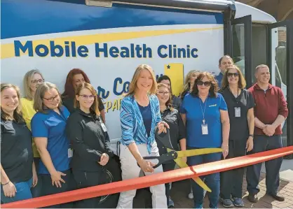  ?? PORTER COUNTY HEALTH DEPARTMENT ?? Porter County Health Officer Dr. Maria Stamp cuts the ribbon Tuesday at the unveiling of the mobile health unit.