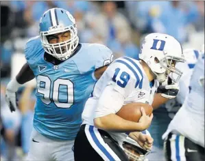  ?? By Bob Donnan, US Presswire ?? Takedown: Quinton Coples (90) wraps up Duke’s Sean Renfree on Nov. 26 for one of his 7½ sacks last season. Coples led the Tar Heels in the statistic despite moving to the right side of the defensive line.