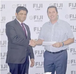  ?? Photo: LITIA TIKOMAILEP­ANONI. ?? Attorney-General and Minister for Public Enterprise and Civil Aviation Aiyaz Saiyed-Khaiyum receives the Tourism Action Group cheque donation from Fiji Airways executive general manager sales and marketing Andrew Stanbury in Nadi yesterday.