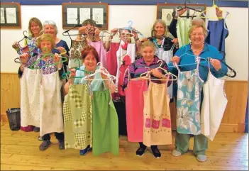  ??  ?? Workshop attendees show a selection of the dresses that they created which will be sent to Africa.