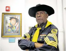  ??  ?? Sgt. Maj. James Williams stands next to a portrait of himself at the Buffalo Soldiers National Museum on Sunday in Houston. Williams is the oldest living Buffalo Soldier at 84 years old.