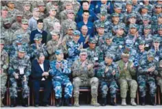  ??  ?? KUNMING, China: US Army Pacific commander Gen. Robert Brown, front row center, and Gen. Liu Xiaowu, front row third right, the commander for Southern Theater Command Army of Chinese Liberation Army (PLA), applaud with their soldiers at a group photo...