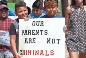  ??  ?? During a protest in Canton, Miss., children of mainly Latino immigrant parents show support for those ensnared during an immigratio­n raid at a food processing plant.
