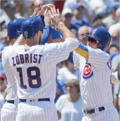  ?? Arbogast, AP) (Photo by Charles Rex ?? Chicago Cubs’ Willson Contreras, right, celebrates his three-run home run off Chicago White Sox starting pitcher Carlos Rodon with Ben Zobrist (18) and Anthony Rizzo during the first inning of Tuesday’s game.