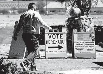  ?? RALPH FRESO/GETTY ?? An Arizona voter makes his way to a polling place to cast his vote Tuesday in Phoenix.