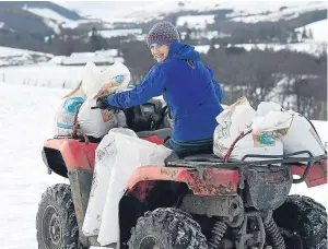  ??  ?? Tilly Smith takes to the quad-bike to get around the wintry slopes.
