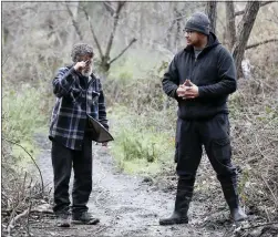  ?? ?? Unhoused Robert Moffitt, 63, talks with Branden Sanchez, of Lighthouse Food Rescue and Distributi­on, as he informs them of the evacuation center in San Jose on Jan. 4. Roberts' tent was flooded on Jan. 1 at Los Lagos encampment at Lone Bluff Park.