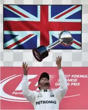  ?? AFP ?? In the file picture, Lewis Hamilton celebrates after winning at F1 Japanese Grand Prix at Suzuka. —