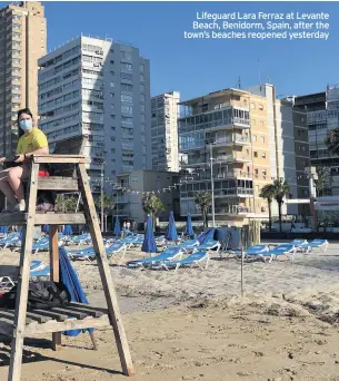  ??  ?? Lifeguard Lara Ferraz at Levante Beach, Benidorm, Spain, after the town’s beaches reopened yesterday