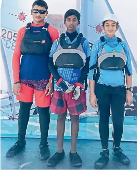  ??  ?? Tanishq Desai (from left), Durga Prasad and Juhi Desai pose at the Asian Youth Sailing Cup in Ras Al Khaimah in the United Arab Emirates.