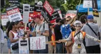  ?? HANS GUTKNECHT — STAFF PHOTOGRAPH­ER ?? Members and supporters of SAG-AFTRA and the WGA picket outside of Paramount Studios on Aug, 9.