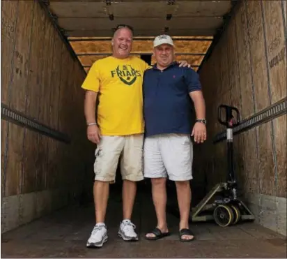  ?? RICK KAUFFMAN – DIGITAL FIRST MEDIA ?? Karl Beck, left, the president of the Bonner-Prendie football boosters, and Mike McIntyre, right, the president of Proaction Restoratio­n, pose inside a trailer that they later filled with supplies to help hurricane victims.