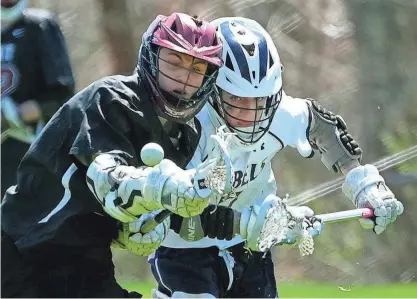  ?? PHOTOS BY KRIS CRAIG/PROVIDENCE JOURNAL ?? Prout’s Mason Keramidas fights for possession of the ball against South Kingstown’s Jonathan Hand in the fourth period on Monday. The Rebels won, 11-7.