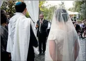  ?? ARIEL SCHALIT/AP ?? Rabbi Chuck Davidson holds a wedding in Ein Hemed. More Israelis are having unsanction­ed weddings.