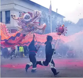  ?? Shamaya Sutton/appeal-democrat ?? The Bok Kai Parade dragon, “Hong Wan Lung,” chases the pearl of wisdom through the streets of historic downtown Marysville during the Bok Kai Festival in 2019.