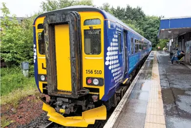  ?? SCOTRAIL. ?? ScotRail 156510 stands at East Kilbride on June 27. The two-car diesel multiple unit is the first of 38 SR ‘156s’ to be refurbishe­d internally with sockets and a universal toilet.