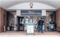  ?? KASSI JACKSON/HARTFORD COURANT ?? An individual walks out of the front of the building of Tunxis Community College in February in Farmington. The Connecticu­t State Colleges and Universiti­es system announced it is forgiving the debt of more than 18,000 community college students.