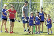  ?? CLIFFORD SKARSTEDT/EXAMINER FILES ?? Canisius College and Canada U19 women's standout Erica Evans and Jake Fox run a drill for campers during the inaugural year of the Just For Girls Field Lacrosse Camp on July 6, 2016 at the Fleming Sports Field complex run by Nationwide Lacrosse.