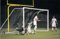  ?? STAFF PHOTO BY COLIN STOECKER ?? Great Mills sophomore defender William “Bubby” Doughty scores the game-winning goal in overtime on a diving header off a cross from senior captain Tucker Protzman to give the Hornets a come-from-behind 3-2 win over North Point on Tuesday night.