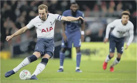  ??  ?? Harry Kane scores from the penalty spot for Tottenham at Wembley.