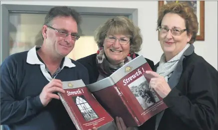  ??  ?? JOURNEY OF DISCOVERY: From left, Simon King, Pam Cupper and Fiona Carine look over copies of Strewth! a book outlining Horsham district involvemen­t in the First World War. The trio will be among a group of 22 visiting battlefiel­ds in Europe. Picture:...