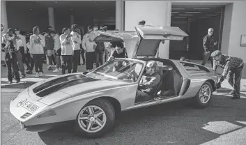  ?? Nick Agro For The Times ?? STUDENTS ON a field trip watch shipping agent Uwe Moser steering an experiment­al 1970 Mercedes.