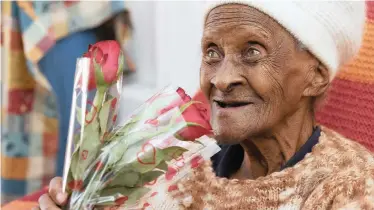  ??  ?? PENSIONER Nonceba Mxenge, 92, was a beneficiar­y in a housing handover in Delft, yesterday, which coincided with Valentine’s Day, so mayoral committee member for Human Settlement­s, Malusi Booi, also gifted beneficiar­ies with roses. |