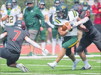  ?? PHOTOS BY SHERRY LAVARS — MARIN INDEPENDEN­T JOURNAL ?? San Marin’s Justin Guin fights for yardage between Redwood defenders Zack Johnson (7) and Hudson Lavinsky (10) during their football game at Redwood High in Larkspur on Saturday. San Marin won 21-14.