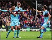  ??  ?? HAPPY HAMMERS: Manuel Lanzini celebrates his late equaliser with Andy Carroll and Aaron Cresswell