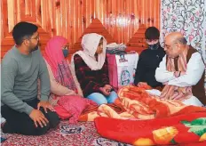  ?? ANI ?? ■ Union Home Minister Amit Shah meets the family members of slain J&K police Inspector Parvez who was killed by terrorists, at Nowgam, in Anantnag yesterday.
