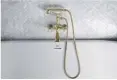  ??  ?? MOST PLUMBING FIXTURES, including in master bath, are brass.