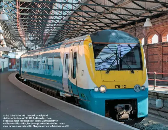  ?? ALAMY. ?? Arriva Trains Wales 175112 stands at Holyhead station on September 21 2014. Rail travellers from
Britain can reach the Republic of Ireland via this relatively easily accessible station, but journeys to Northern Ireland take a more tortuous route via rail to Glasgow and bus to Cairnryan.