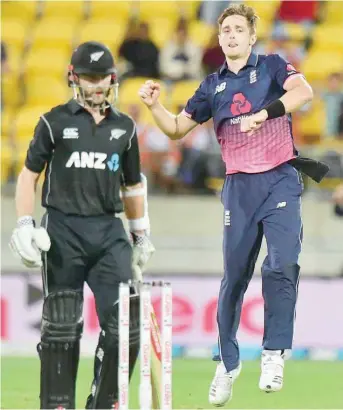  ??  ?? England’s Chris Woakes (right) celebrates his team’s win as New Zealand’s captain Kane Williamson stands dejected during the third ODI at Westpac Stadium in Wellington. — AFP