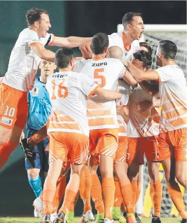  ?? Pictures: JUSTIN BRIERTY ?? HOWLING SUCCESS: Cairns FC player Ryan Cavanah celebrates with teammates after he kicks the first goal during match against Sydney FC at Barlow Park.