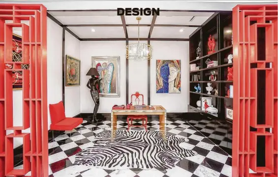  ?? Luis Urdaneta / Next Listing ?? Fretwork painted bright red adds a giant pop of color in the first-floor home office.