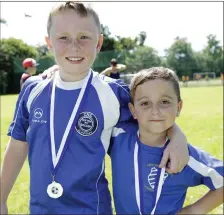  ??  ?? Jack Gill and Daniel Crean with their medals at the Ashford Rovers mini World Cup.