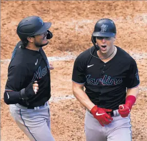  ?? NAM Y. HUH/AP ?? Miami Marlins' Miguel Rojas celebrates with Corey Dickerson, right, after Dickerson hit a three-run home run that scored Rojas and ChadWallac­h in the seventh inning of Game 1 of the best-of-three National League wild-card series.