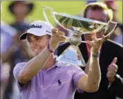  ?? CURTIS COMPTON — ATLANTA JOURNAL- CONSTITUTI­ON VIA AP, FILE ?? In this file photo, Justin Thomas holds the trophy after winning the Fedex Cup after the Tour Championsh­ip golf tournament at East Lake Golf Club in Atlanta.