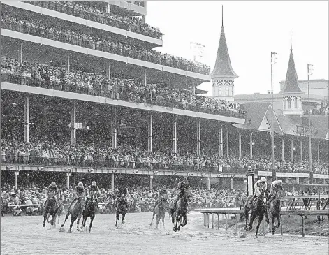  ?? AP/DARRON CUMMINGS ?? (second from right) takes Justify into the first turn during Saturday’s Kentucky Derby at Churchill Downs in Louisville. Justify became the first horse since Apollo in 1882 to win without racing as a 2-year-old. Justify has won all four of his career...