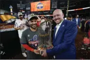  ?? DAVID J. PHILLIP — THE ASSOCIATED PRESS ?? Houston Astros second baseman Jose Altuve and general manager James Click celebrate with the trophy after their 4-1World Series win against the Philadelph­ia Phillies in Game 6 on Nov. 5.