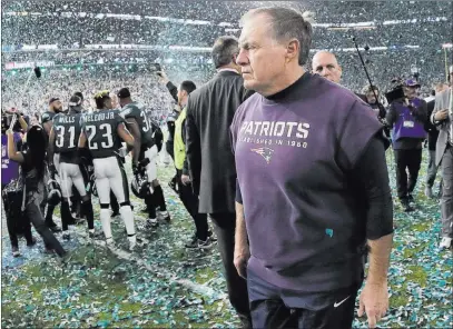  ?? Mark Humphrey ?? The Associated Press Patriots coach Bill Belichick leaves the field following the Eagles’ 41-33 victory in Super Bowl LII on Sunday in Minneapoli­s.