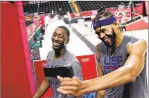  ??  ?? BAM ADEBAYO, left, and JaVale McGee smile for the camera. McGee was a late addition after a couple of players pulled out.