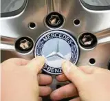  ??  ?? Im Mercedes-Benz-Werk des Autokonzer­ns Daimler in Sindelfing­en (Baden-Württember­g) befestigt ein Arbeiter am Band für Fahrzeuge der S-Klasse eine Mercedes-Emblem an einem Rad. Foto: B. Weissbrod