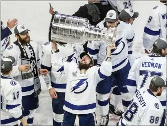  ?? ASSOCIATED PRESS FILE PHOTO ?? Tampa Bay Lightning’s Nikita Kucherov (86) hoists the Stanley Cup after defeating the Dallas Stars in the 2020 Stanley Cup hockey finals in Edmonton, Alberta. Kucherov is expected to miss the entire regular season because of a hip injury that requires surgery. General manager Julien BriseBois ruled out Kucherov for the 56-game season that begins Jan. 13 and ends May 8.