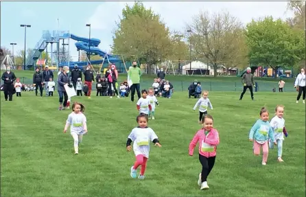  ?? CHAD FELTON — THE NEWS-HERALD ?? Youngsters in the Pre-K 50-yard dash leg of Healthy Kids Running Series speed toward the finish line at Coulby Park in Wickliffe. The national nonprofit event made its debut in the city on April 25and drew about 150registr­ants.