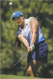  ??  ?? St. Michael’s Carisa Padilla chips onto the green prior to claiming second place in the individual championsh­ip.